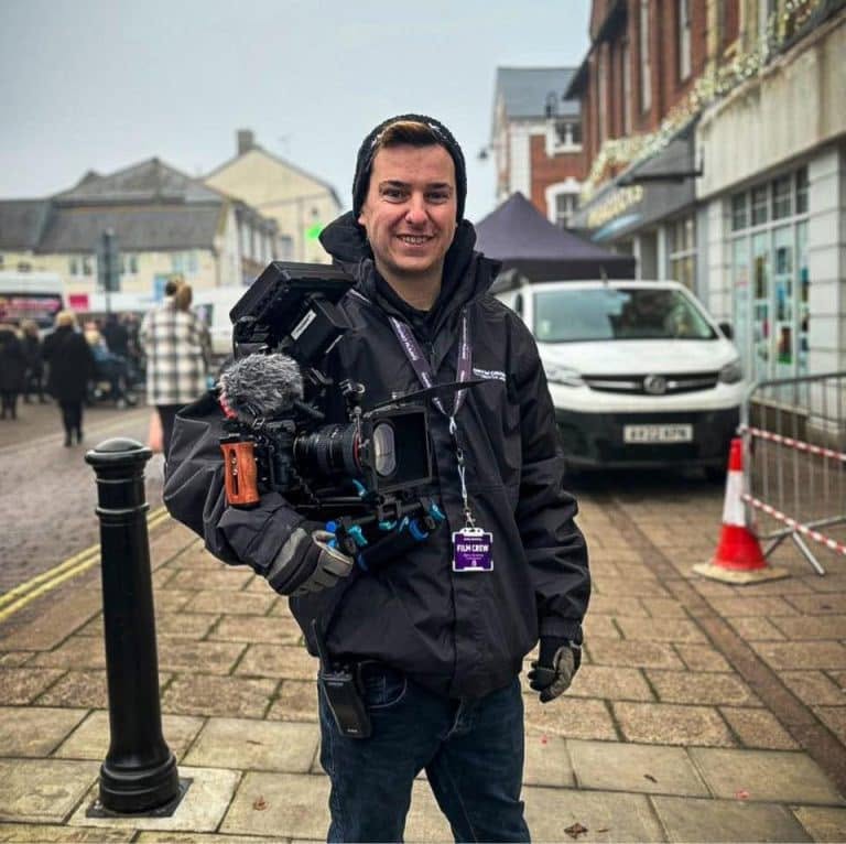 Danny Grimshaw smiling and holding a production camera